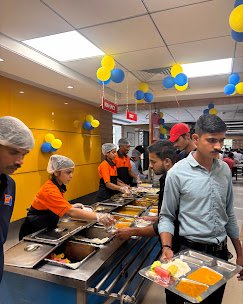 SLP staff serving a busy buffet line at a client canteen